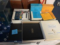 Lot of four Trivial Pursuit games including white Walt Disney edition box with Mickey Mouse, multiple question card boxes and game pieces.