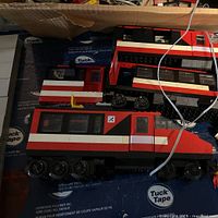 Red and white locomotive engine sections laid out on branded paper