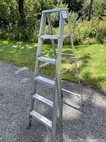 Front side view of the 6ft aluminum step ladder showing condition and step configuration.
