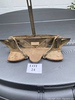 Front view of the heavy-duty miter trimmer showing the cast iron frame and blade holders with springs.