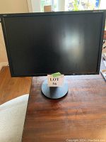 Front view of NEC MultiSync EA234WMi monitor displaying the black screen and round base stand.