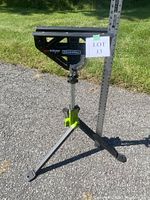 Full view of the Rockwell RK9034 JawStand XP Work Support Stand assembled and standing on pavement with a measurement stick next to it showing height.