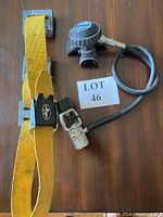 Sherwood Blizzard dive regulator with yellow dive belt laid flat on a wooden surface with lot tag