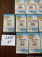 Front view of several X10 module boxes including Wall Switch Modules, Security Motion Sensor, 3 Pin Grounded Appliance Module.