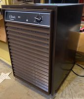 Full view of Woods Classic Frostguard D25 dehumidifier unit showing front air vent panel and side.