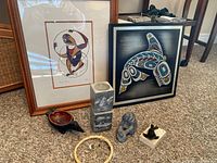 Overall view showing framed prints and sculptures arranged on carpet