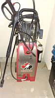 Front angle showing the pressure washer unit with Hockey Canada logo and attached hose and spray gun.