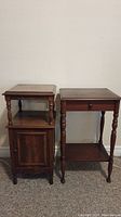 Two small wooden side tables side by side, showing front and overall shape. Left table with carved floral inlay cabinet door, right table with drawer and shelf.