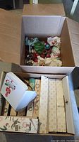 Open cardboard box showing loose and boxed ornaments
