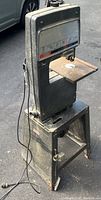 Photo of Sears Craftsman 12 inch band saw from angled side view showing metal stand, work table and saw body with power cord