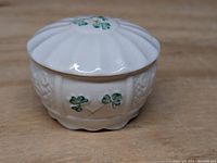 Front view showing three green shamrocks on jar body and lid