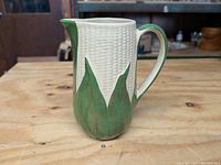 Front view of the ceramic King Corn pitcher showing corn kernel texture and green husk detail.