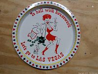 Photo of vintage steel serving tray with cartoon woman and Las Vegas text