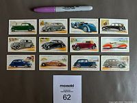 Lot of 12 vintage John Player's 1937 Motor Cars tobacco cards, laid out with a marker for size reference.