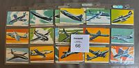 Front side view showing 15 color illustrated warplane cards in plastic binder sleeves, each card depicting a different aircraft against colored backdrops.