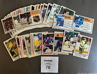 Lot of 57 assorted 1981-82 O-Pee-Chee hockey cards fanned out in multiple stacks showing a variety of players and card backs.