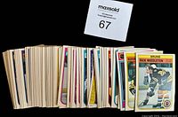 Stack of 68 1982-83 O.P.C. hockey cards showing edges and some front cards like Rick Middleton
