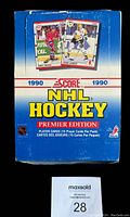 Front view of the 1990 Score NHL Hockey wax box featuring player cards of Chris Chelios and Mario Lemieux illustrated on the box.