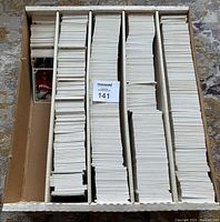 Large monster box containing multiple rows of approximately 4,000 unsorted 1990 Upper Deck baseball cards fan-folded and stacked neatly with mostly card backs visible.