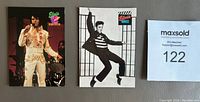Three Elvis Presley cards displayed showing front images including one in white jumpsuit performance, one black and white movie still, and one colorful portrait.