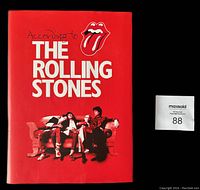 Front cover of the book showing red dust jacket featuring The Rolling Stones logo, title and band photo.