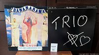 Photo showing both vinyl covers: Bananarama "Venus" with colorful artistic cover and Trio "Da Da Da" with minimalist black and white cover with hand-drawn style text and hearts.