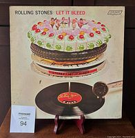 Front cover of the Rolling Stones 'Let It Bleed' 1969 LP showing iconic cake and record artwork with some handling wear visible.