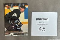 Photo showing the full front of the Wayne Gretzky 1993-94 Fleer Ultra hockey card with autograph in blue Sharpie.