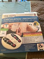 Front view of the boxed Dr. Ho's Circulation Promoter device showing branding, device purpose, and health claims.