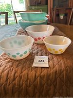 Three vintage milk glass polka dot bowls in various colors and sizes