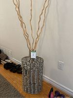 Full view of the metal mesh standing vase with birch wood decor sticks inside, shows the overall height and shape
