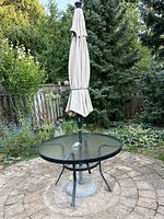 Full view of patio set on a stone patio with garden background