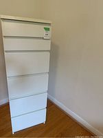 Front view of white IKEA dresser showing six drawers