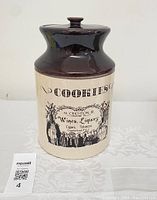 Front view of the large pottery cookie jar with lid, showing the transfer design and overall shape.