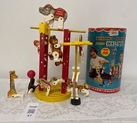 Photo showing the assembled Junior Circus play set with animal figures and original box visibly behind. Clear view of toy figures and structure.