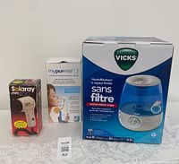 All three boxed items: Solaray Mini 1200 hair dryer, mypurmist 2 handheld steam inhaler, and Vicks filter-free cool mist humidifier.