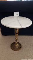 Full view of side table showing marble top and brass base