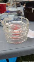 Clear stacked glass ashtrays showing ridged design and size