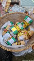 Photo of multiple wrapped Bee and Flower soap bars in a wicker basket with white liner.
