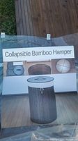Photo of packaging label depicting the collapsible bamboo hamper and its features.