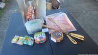 Photo of incense and related accessories on a black table outdoors