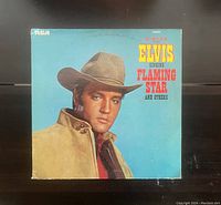 Album cover of Elvis Presley Singing Flaming Star and Others showing artist portrait and title text on blue background.
