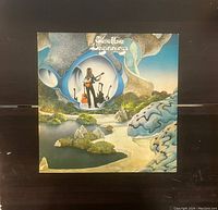 Front cover of the 'Beginnings' vinyl record by Steve Howe showing detailed illustrative artwork including a surreal landscape and image of the artist with guitar.