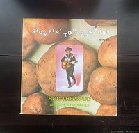 Front cover of the vinyl record titled 'Bud The Spud and Other Favourites' by Stompin' Tom Connors featuring image of artist and potatoes.