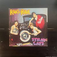 Front cover of the Stray Cats Rant N Rave vinyl record album showing the band members and vintage car wheel.