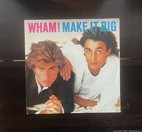 Photo of the vinyl record cover titled 'WHAM! Make It Big', showing the two band members on the front with the album title in pink and blue text.