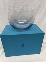 Large clear crystal bowl with a purple blue gradient tint inside, resting on top of a blue Birks gift box.