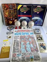 Wide shot showing entire 1992 Toronto Blue Jays World Series collection including signed baseballs, World Series programs, newspaper, cards, pins, and tickets.