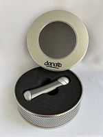 Donato lighter inside original round metal gift tin box with clear window lid, foam insert