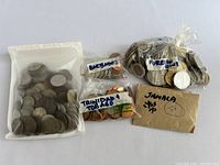 Four plastic bags and an envelope: labeled 'Foreign 1940's', Barbados, Trinidad & Tobago, and an envelope labeled 'Jamaica'. Coins of varying metallic tones inside each.